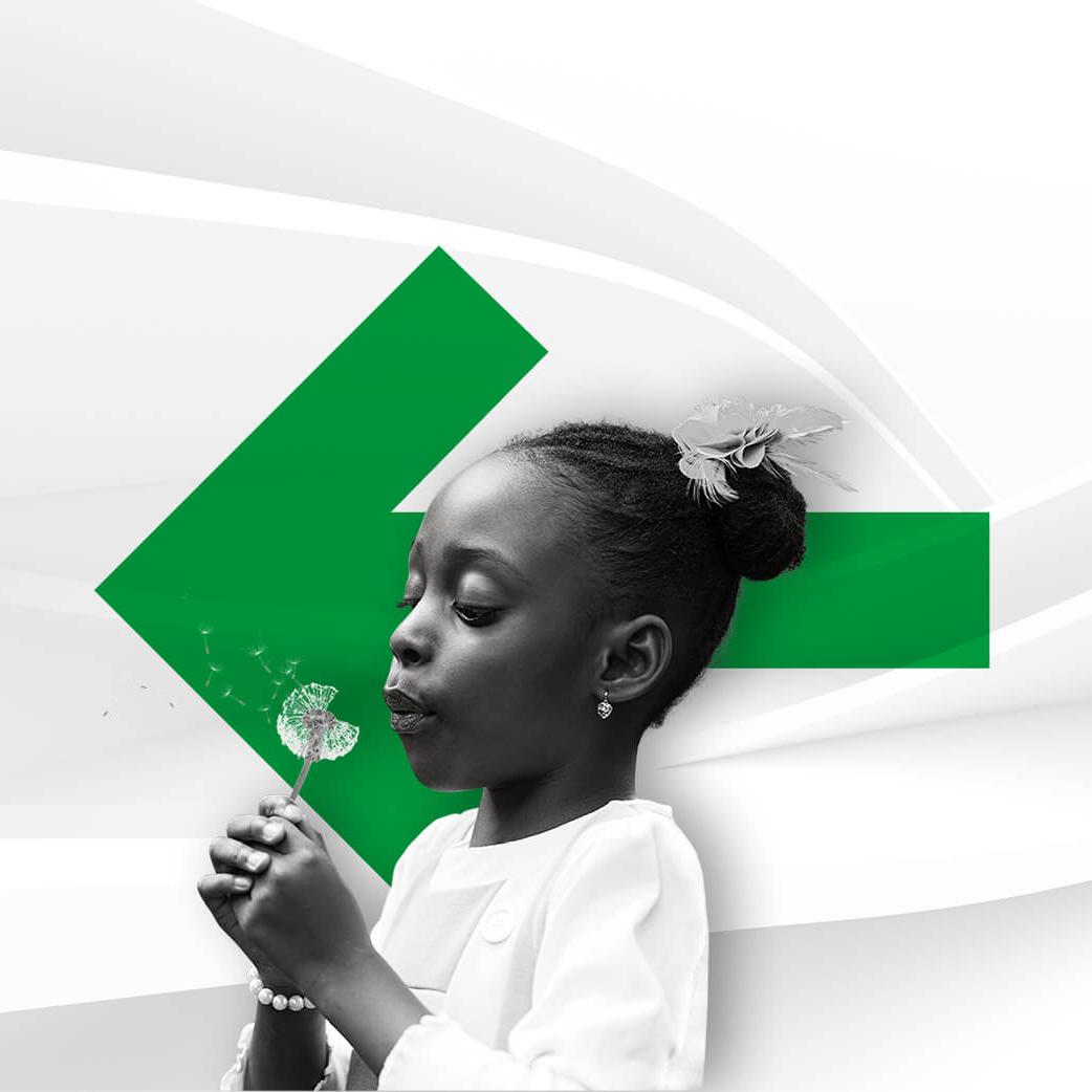 Black girl blowing a dandelion, in front of a large green arrow